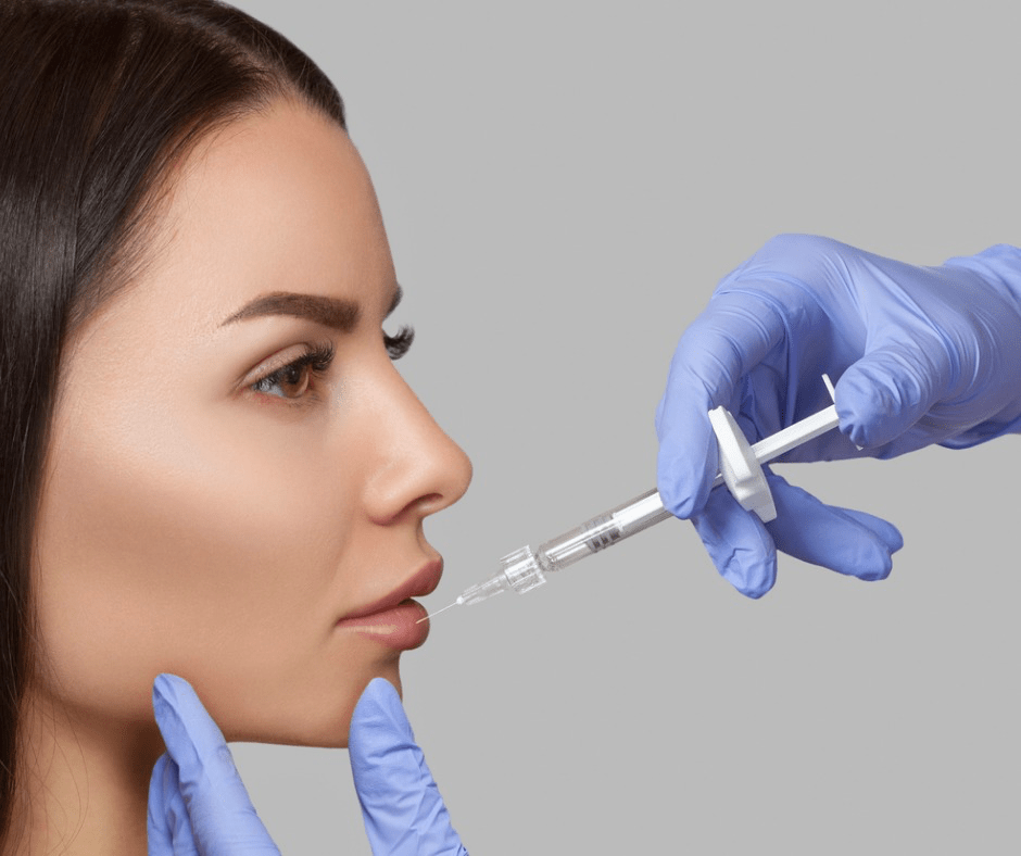 the-doctor-cosmetologist-makes-lip-augmentation-procedure-of-a-woman-picture-id1209194736