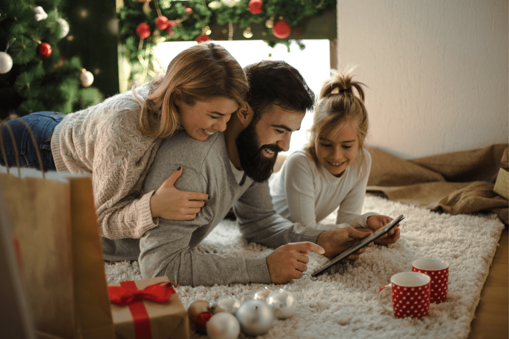 Family looking at an ipad for Christmas Gift Ideas